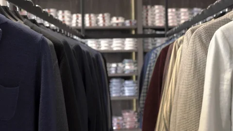 Close-up demonstration video of a great choice of male clothes in boutique. Video stock 107460812