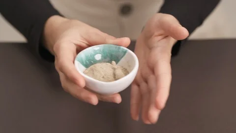 Close-up demonstration video of a woman's hands holding ceramic bowl with Stock Footage 118308717