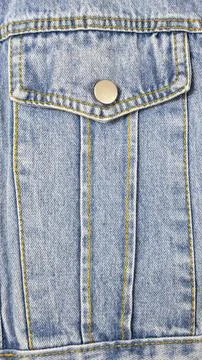 A close-up of a denim jacket pocket. Denim texture background. 스톡 사진