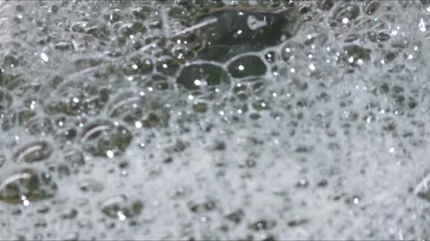 Close-up of dense white foam with bubbles, abstract texture. Stock Footage 323114527