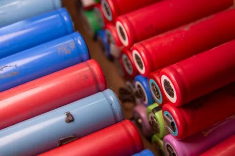 Close-up of densely packed lithium-ion batteries in various bright colors. Stock Photos