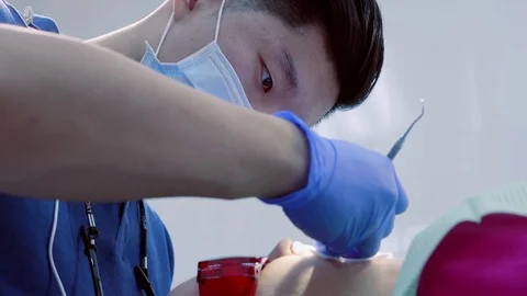 Close up of dental equipment in hospital with patient lying on exam chair and Stock Footage