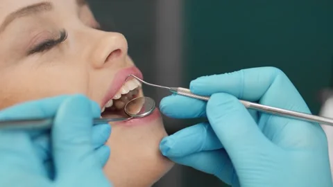 Close up of a dental examination with a dentist using professional tools to 库存影片 341035306