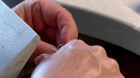 Close up of a dental technician's hands working on a crown (dentures) Video stock 76780255