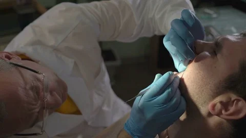 Close-Up of Dentist Using Dental Tool Forms From the Photopolymer Material Stock Footage 76556689