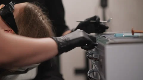 Close up of dentist wearing gloves preparing orthodontic instruments on metal Stock Footage 345074780