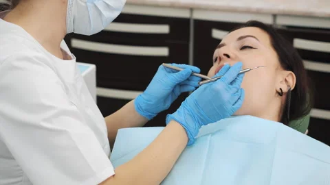 Close-up of the dentists hand treating teeth of a little girl in clinic. Stock Footage 317171805