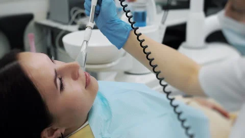 Close-up of the dentists hand treating teeth of a little girl in clinic. Stock Footage 317172294