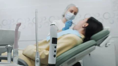 Close-up of the dentists hand treating teeth of a little girl in clinic. Stock Footage 317295982