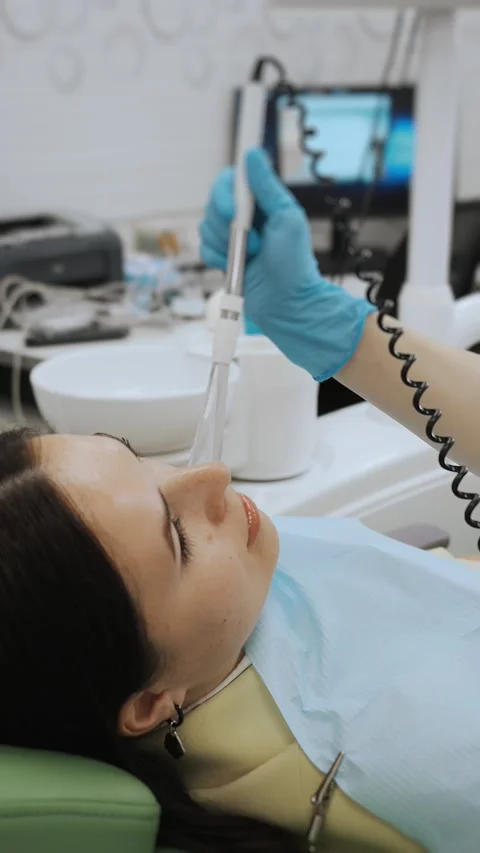 Close-up of the dentists hand treating teeth of a little girl in clinic. Stock Footage 317797616