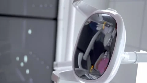 Close-up of dentist's hands adjusting light. Stock Footage 258744751