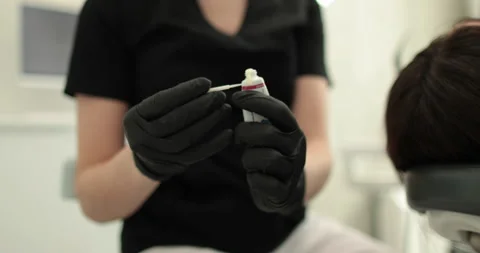 Close-up of dentist's hands holding dental tools and toothpaste. Stock Footage 254070168