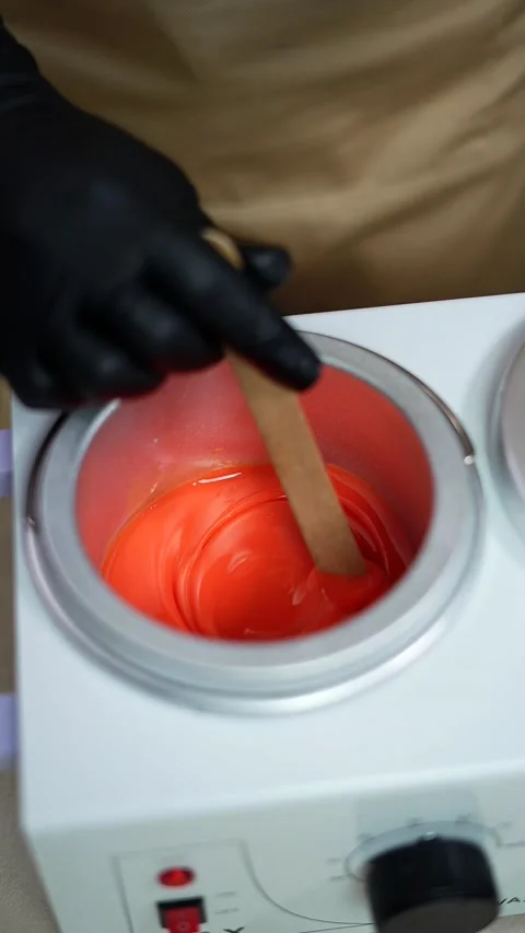 Close-up of depilation master hands holds spatula with melted wax. 9:16 Stock-Footage 233826005