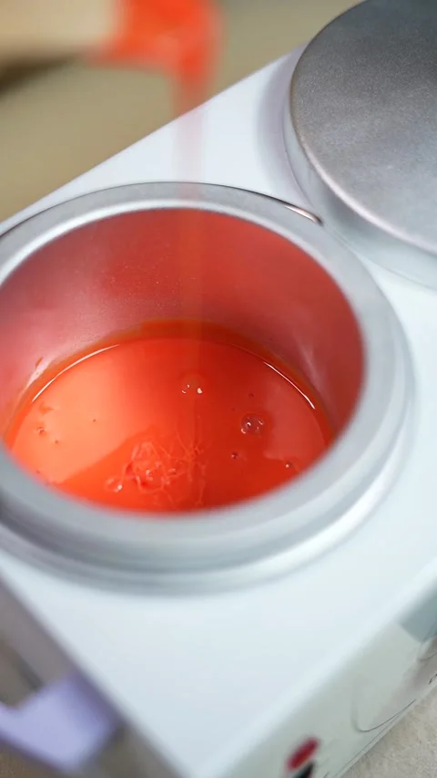 Close-up of depilation master hands holds spatula with melted wax. 9:16 Stock Footage 233826018