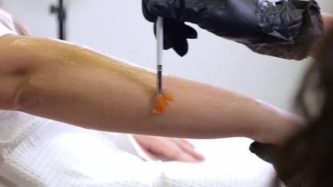 Close-up of the depilatory master applying gel to the clients hand. Stock Footage 321815300