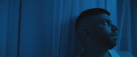 Close up of a depressed man sitting in the bedroom, dealing with post trauma. Stock Footage 147537713