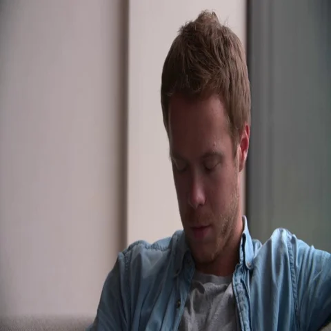 Close Up Of Depressed Young Man At Home Stock Footage