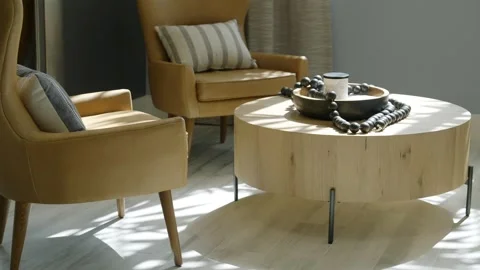 Close up of design yellow armchairs with striped cushions arranged near round Stock Footage 242942053