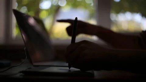 Close-up of designer hands working at laptop and graphic tablet. Background of w Stock Footage 116267274