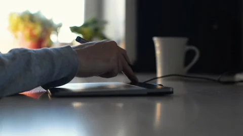 Close-up of designer, illustrator using graphics tablet and pen  indoors . 스톡 동영상 197997612
