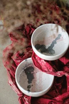 Close-up designer light painted ceramic bowls on red background Stock Photos