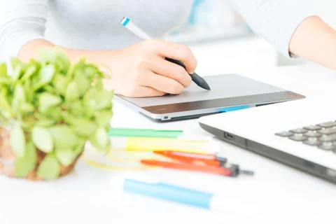 Close up designer using graphic tablet design on desk Stock Photos