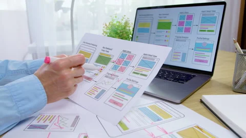 Close-up of a designer using a marker to edit printed mobile application  Stock Footage 341940153