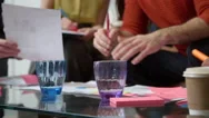 Close Up Of Designers Meeting Around Table In Modern Office Stock Footage