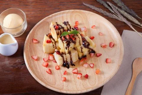 Close up of dessert which has Bread, strawberry berries, caramel and put pepp Stock Photos