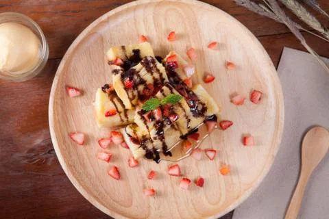 Close up of dessert which has Bread, strawberry berries, caramel and put pepp Stock Photos