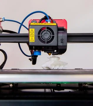 Close-up detail of 3D printer printerhead with hotend and fan. Little plastic Stock Photos