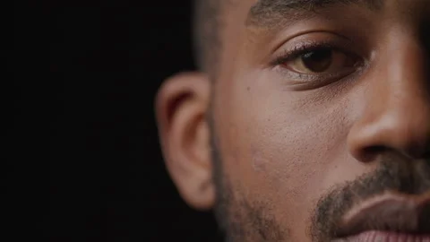 Close up detail of Half face of african american man looking into camera Stock Footage 208784232
