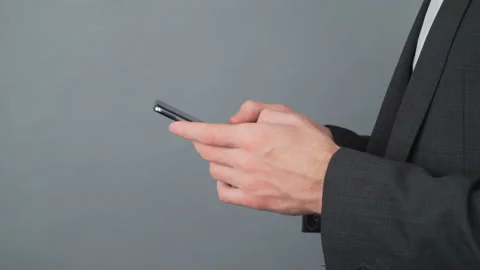 Close-up detail on isolated gray background. Male hands in a business jacket Stock Footage 153845467