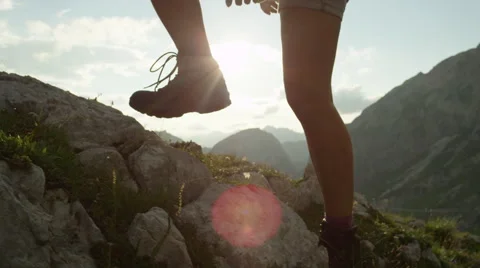 CLOSE UP: Detail of leather mountain shoes and woman climbing steep mountaintop Stock Footage