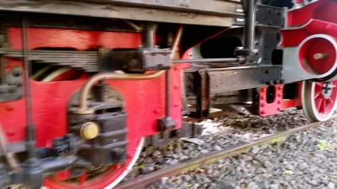 Close up detail of small copper steam pipes and wheels of an old lokomotive Stock Footage 93888076