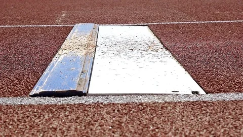 Close detail of Sportsman leg doing long jump touching the board, slow motion Stock Footage