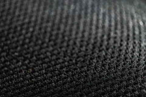 Close-up detail of textured shoe surface set against a dark background Stock Photos
