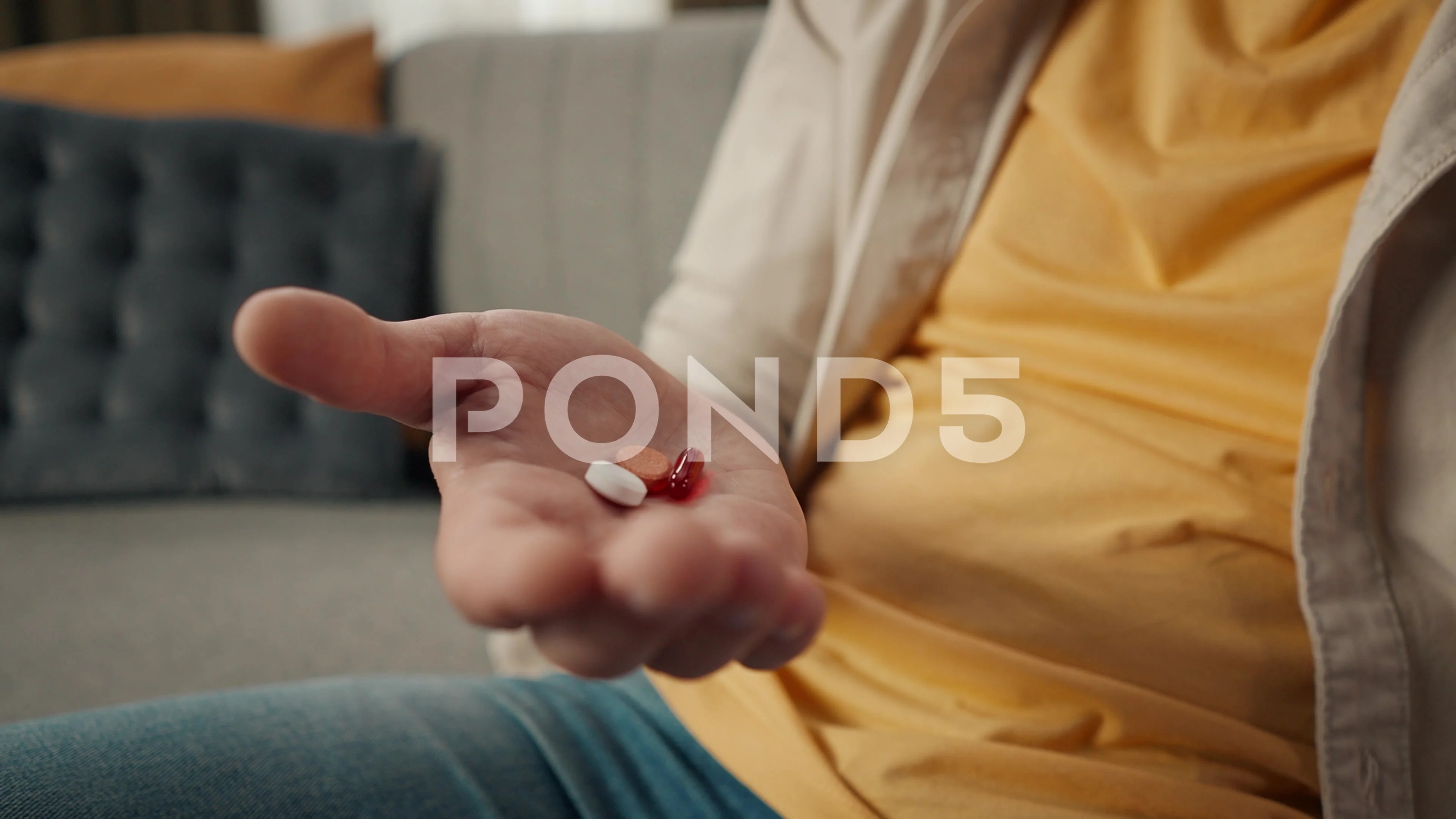 Close-up, detail video of the palm of a middle-aged man sitting on a couch,  sofa