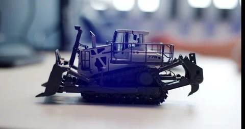 Close up of detailed scale model of bulldozer on desk in office Stockbeeldmateriaal 329564514