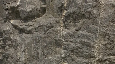 Close up detailed texture of dark gray jagged rock wall the rugged surface Stock Footage 340264481