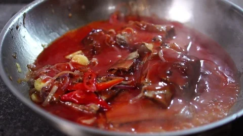 Close up detailed view on adding water to delicious pork and vegetable stew on Video stock 106813266