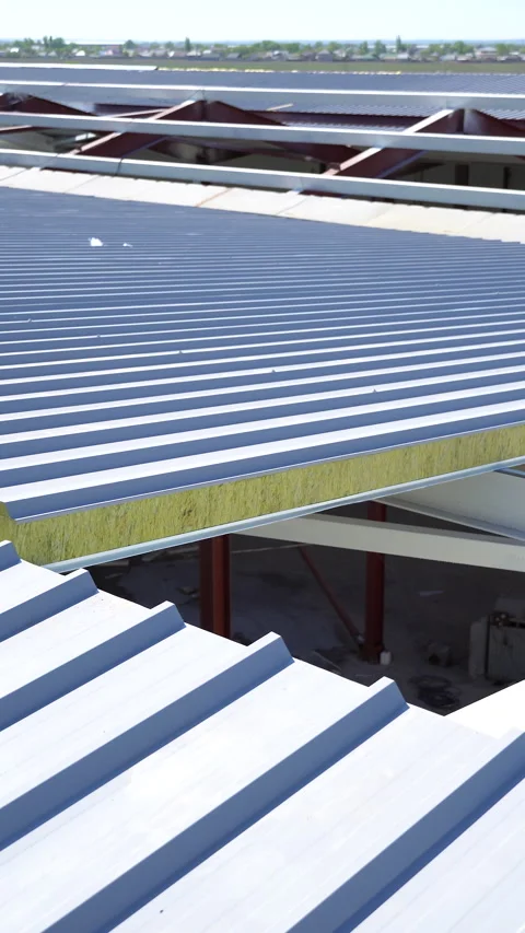 A close-up detailed view of the installed sandwich panel on the roof of a wareho Stock Footage 335795712