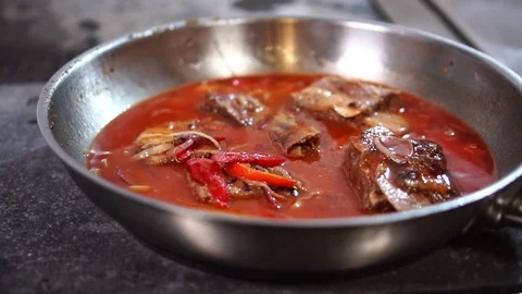 Close up detailed view on vegetable pork ragout simmering in hot tomato sauce on Stock Footage 106813524