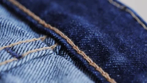 Close up of details and elements of jeans. Stitched seams. Texture of fabric Stock Footage 314333517