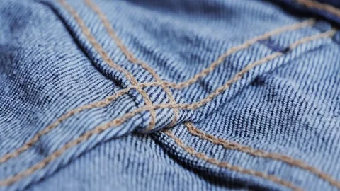 Close up of details and elements of jeans. Stitched seams. Texture of fabric Stock Footage 314333651