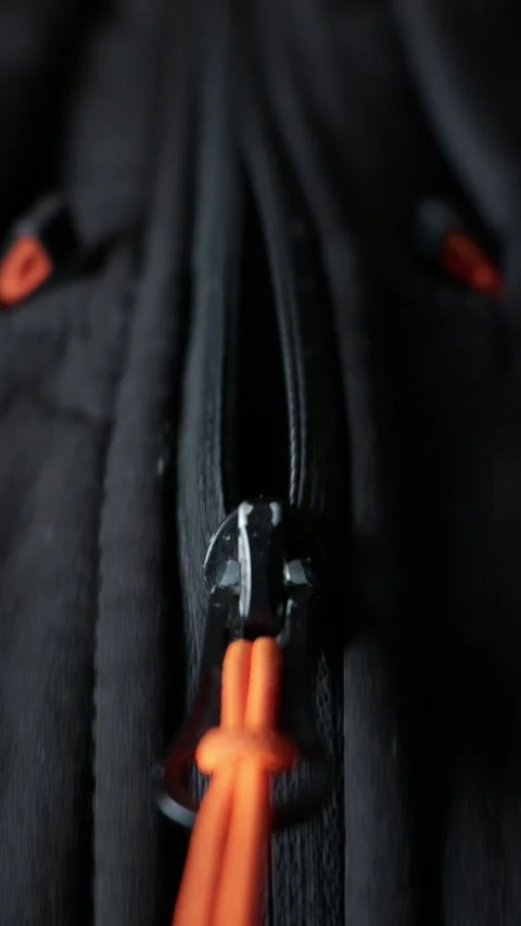 Close Up Details of Black Jacket Zipper with Bright Orange Pull Cord Video stock 338096849