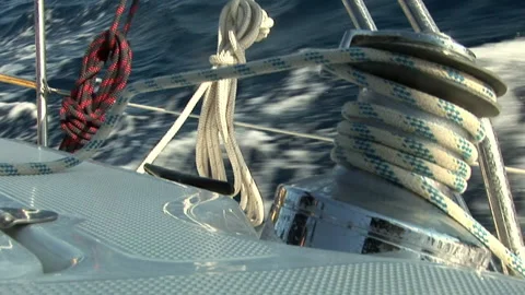 Close up details of deck and white sail of moving sailing yacht. Видео 155150039