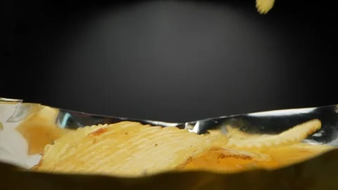 Close-up details of picking up crispy potato chips from a bag Stock Footage 244801582