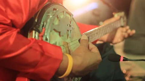 Close up details of a traditional stringed instrument being played in a band Stock Footage 100798737