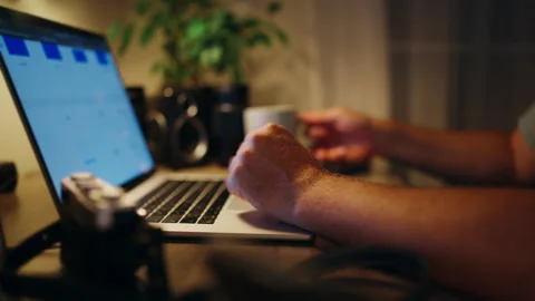 Close-up of a determined man working late into the night on his laptop, tak.. Stock Footage 346781442